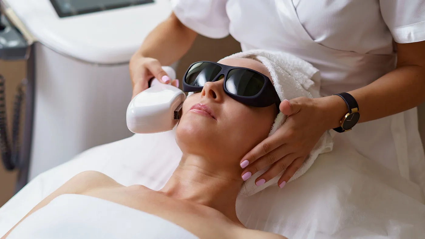 Patient wearing protective goggles receiving a laser skin resurfacing treatment