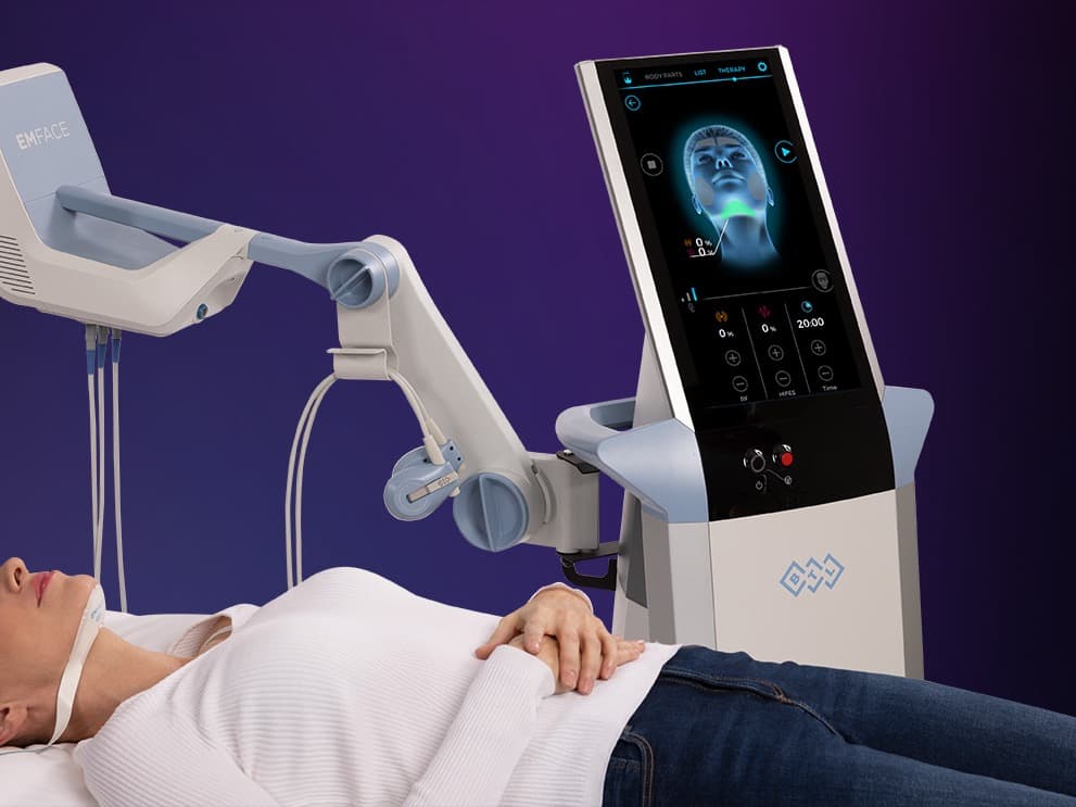 EMFACE Submentum machine treating a patient lying down with the chin applicator in place