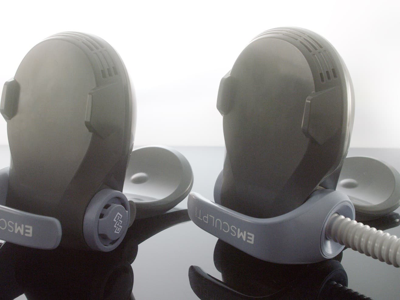 Pair of Emsculpt NEO Edge applicators on a treatment table