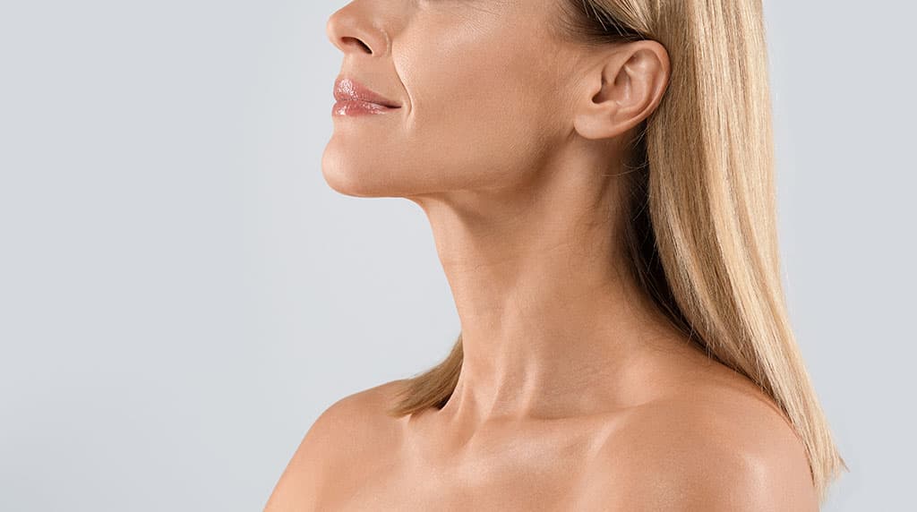 Profile of a woman's smooth, firm neck and jawline after non-surgical skin tightening