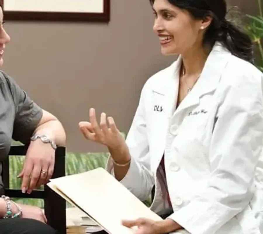 A patient being talked through her breast reduction options in a consultation room at the practice
