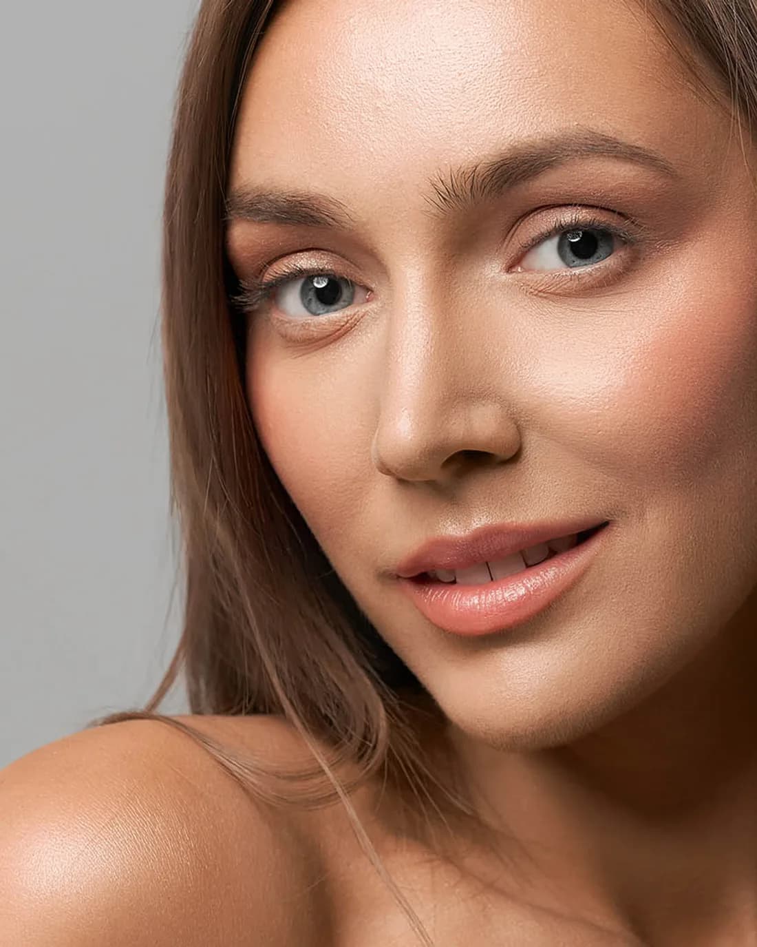 Close portrait of a woman with clear, even skin after laser acne treatment