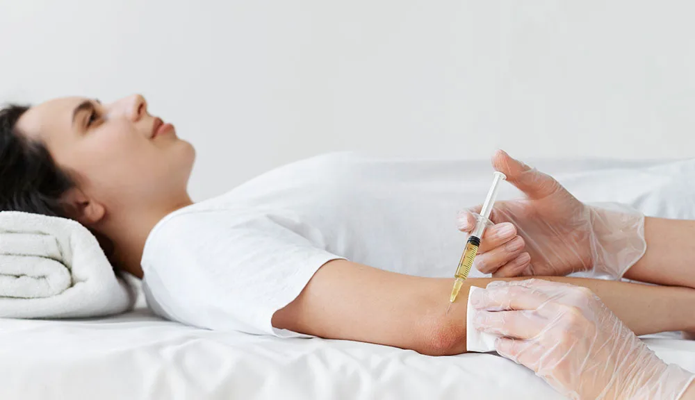 Clinician administering a vitamin B12 injection into a patient's arm