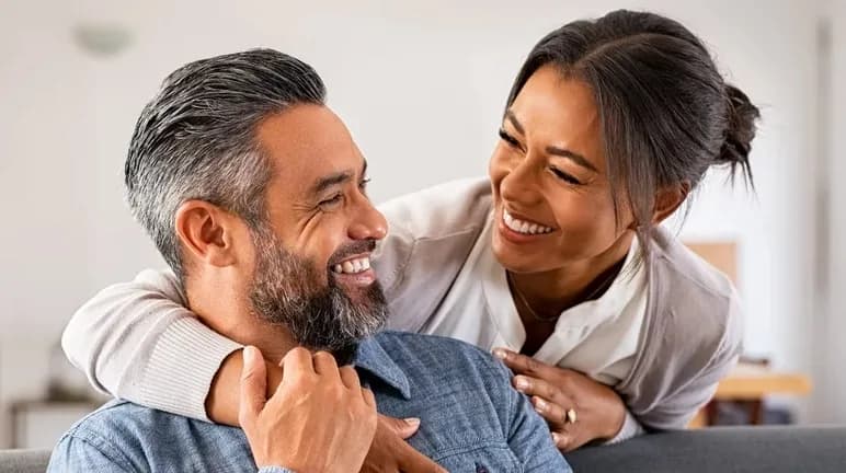 Middle-aged couple relaxing together on a couch at home