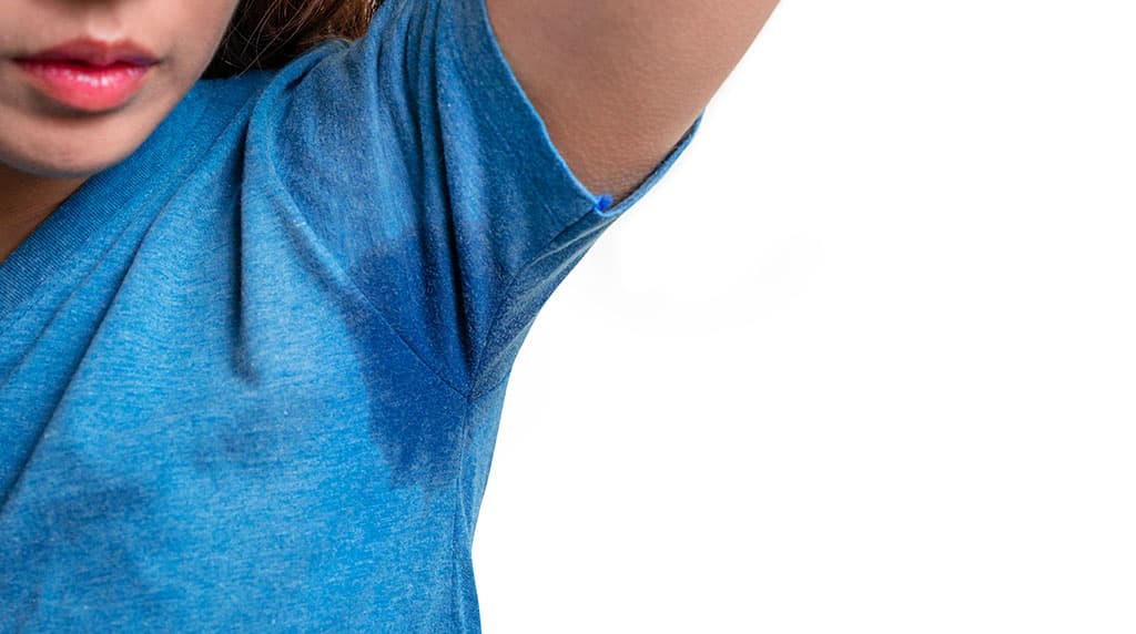 Sweat-soaked underarm of a blue shirt, the excessive sweating Botox treats