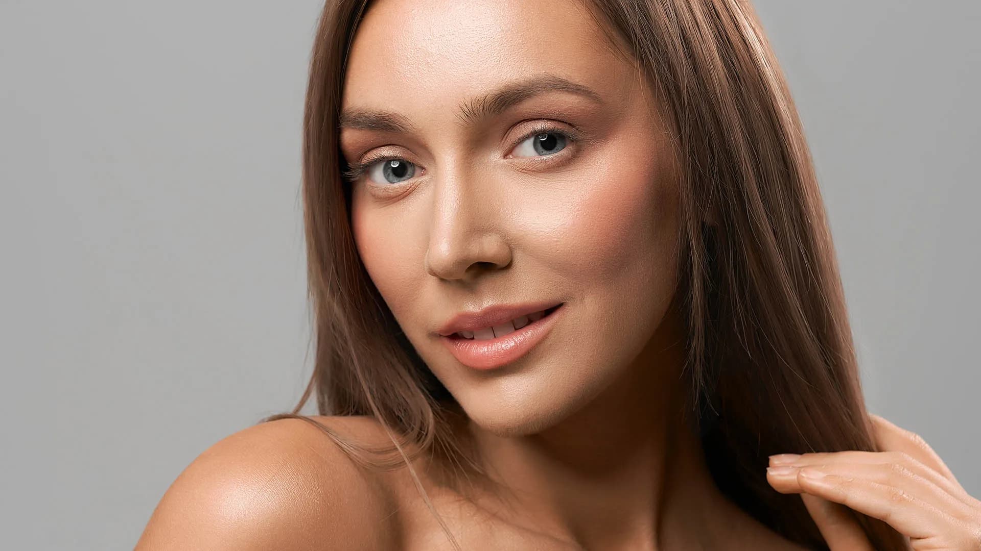 Woman with smooth, radiant skin after Clear + Brilliant treatment