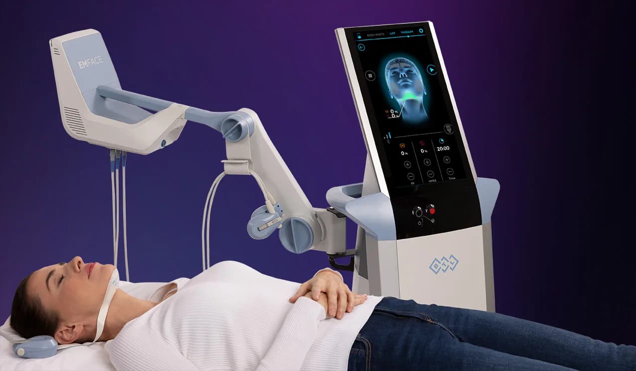 EMFACE machine with a patient wearing the submental applicator under the chin