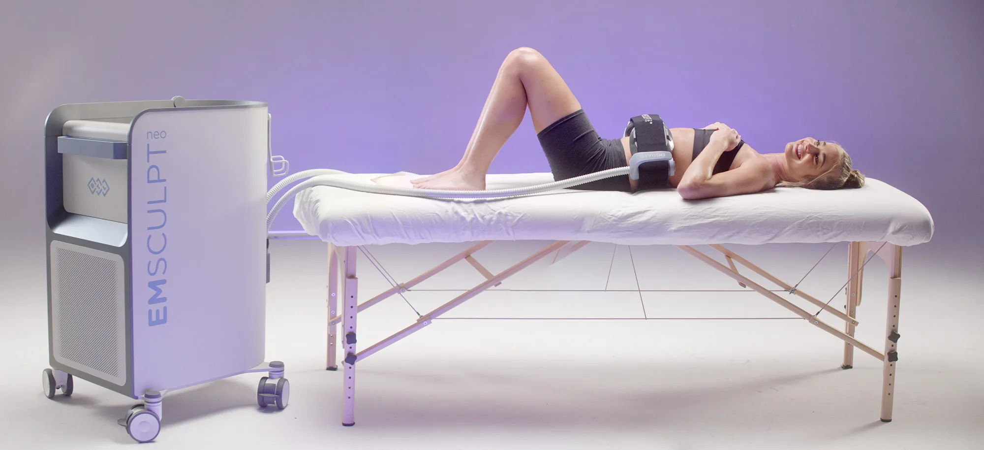 Patient receiving an Emsculpt NEO treatment on the abdomen at The Dermatology, Laser & Vein Center