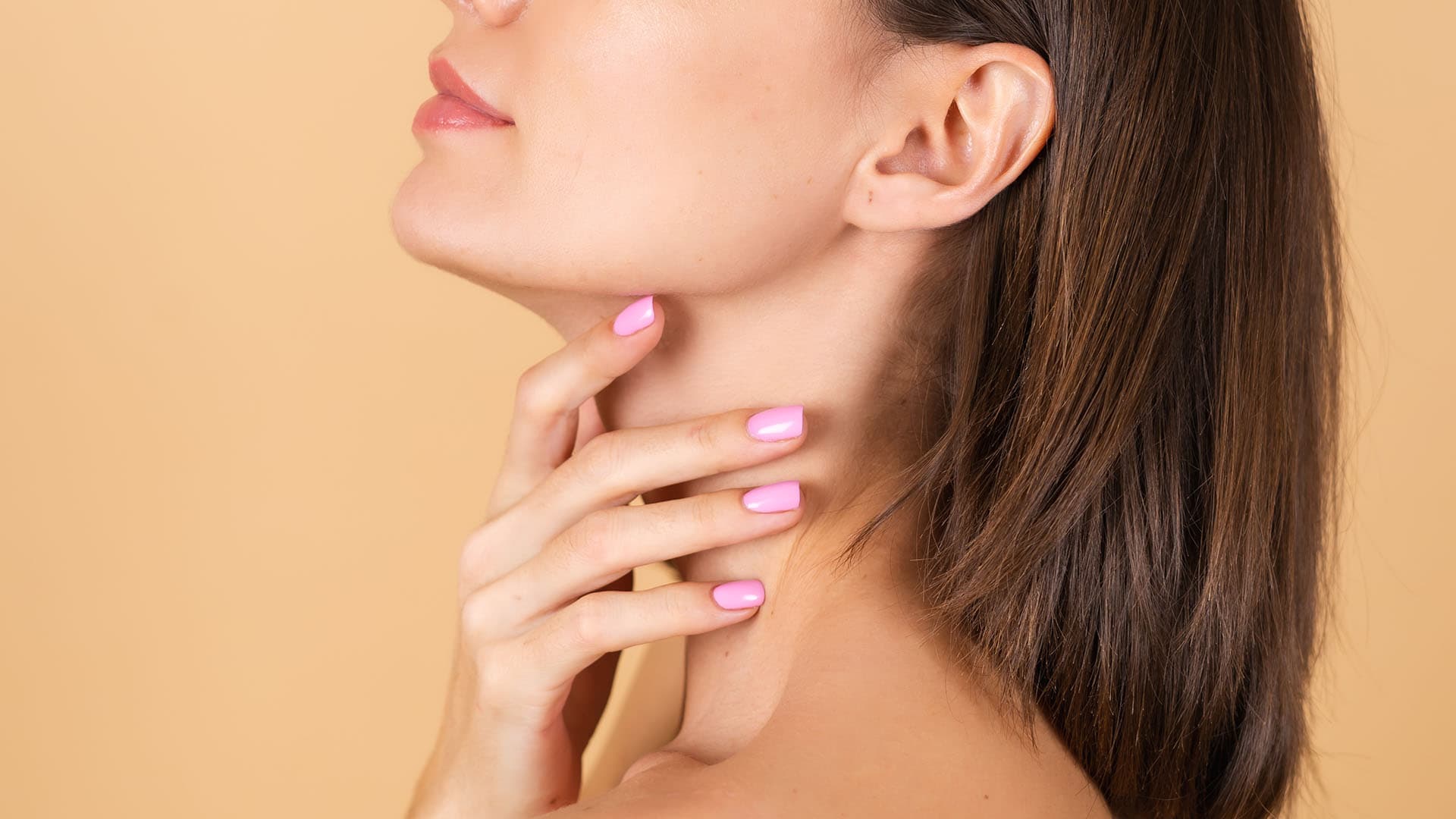 Woman touching the smooth contour of her chin and jawline after Kybella