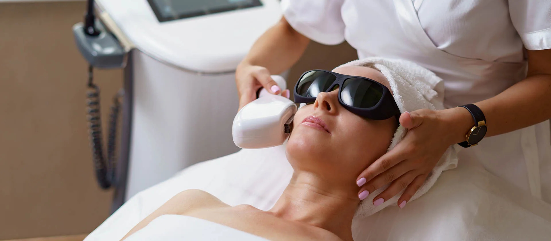 Patient wearing protective goggles during a light-based facial treatment