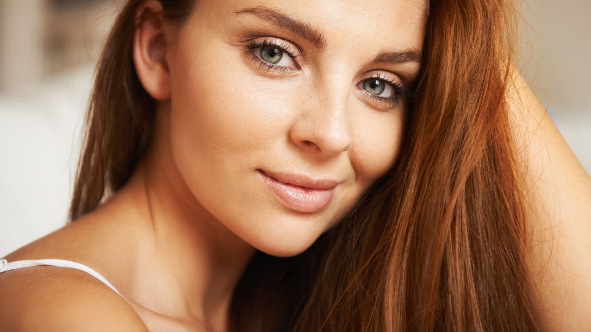 Woman with firm, smooth skin, from the practice's Sculptra page banner