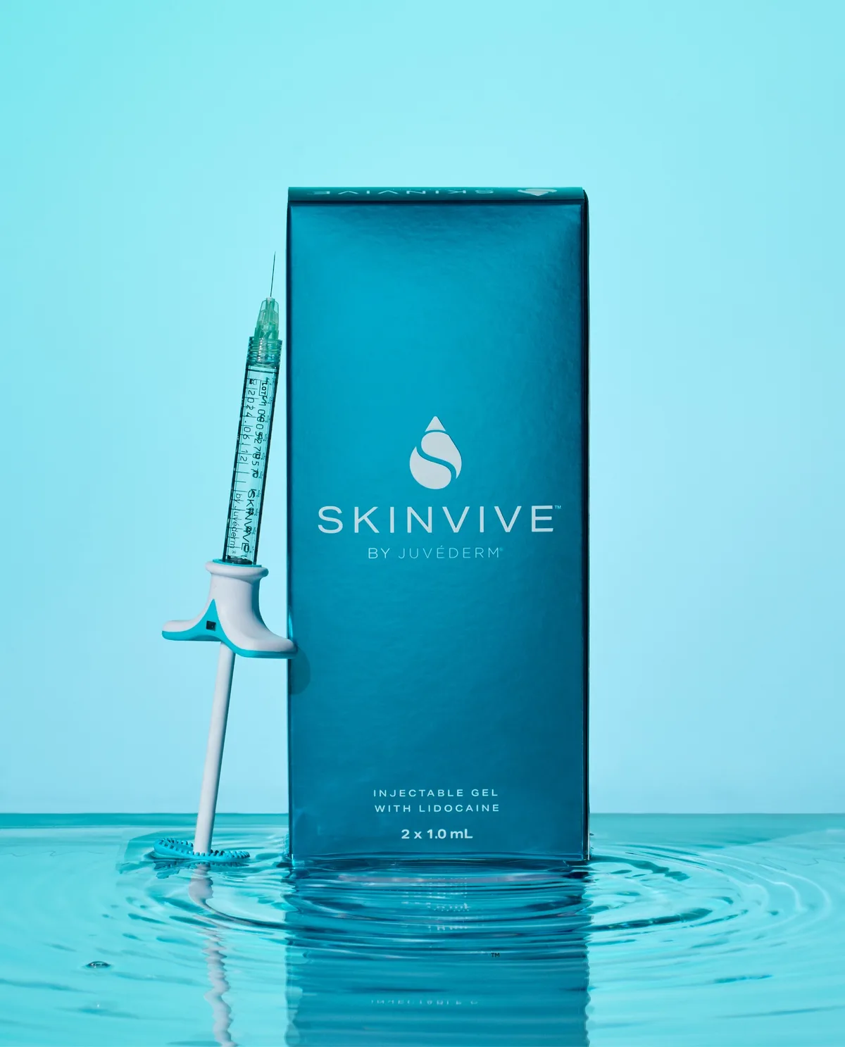 SKINVIVE by Juvederm product box and syringe in rippling water