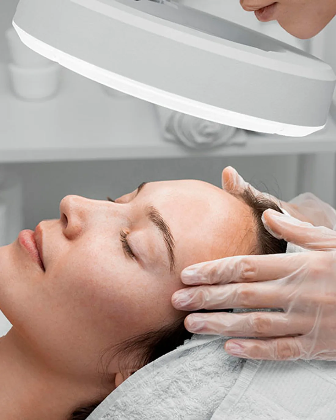 Patient receiving a treatment to the face and neck in a treatment room at the Montgomery Road office